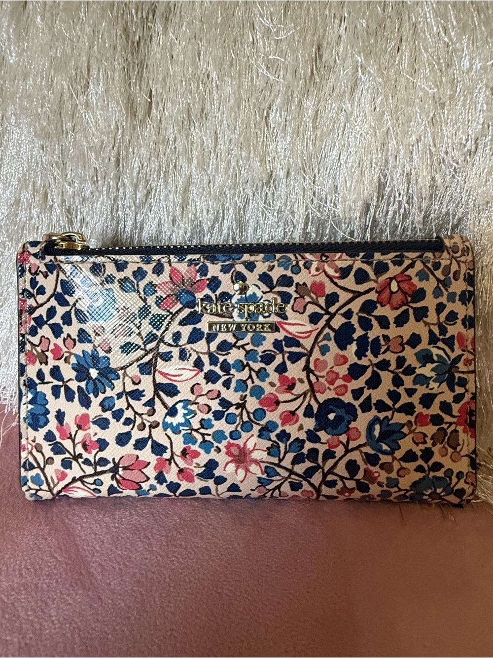 KATE SPADE small floral zip wallet in cream, blue and pink floral pattern.